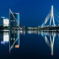 View of the Vanšu bridge and the Swedbank headquarters as seen from the waterfront at night